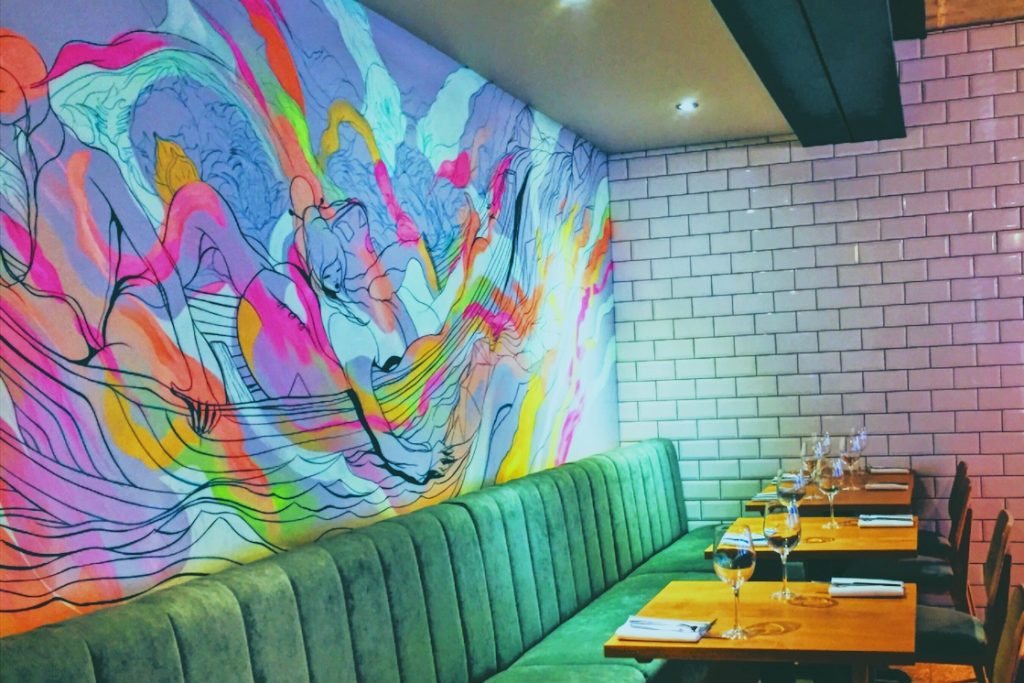 The mural at Farmyard Norwich restaurant adds to the atmosphere